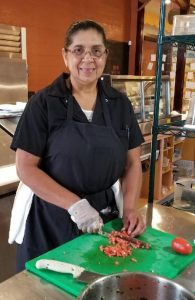 Ofelia Anorve prepares food