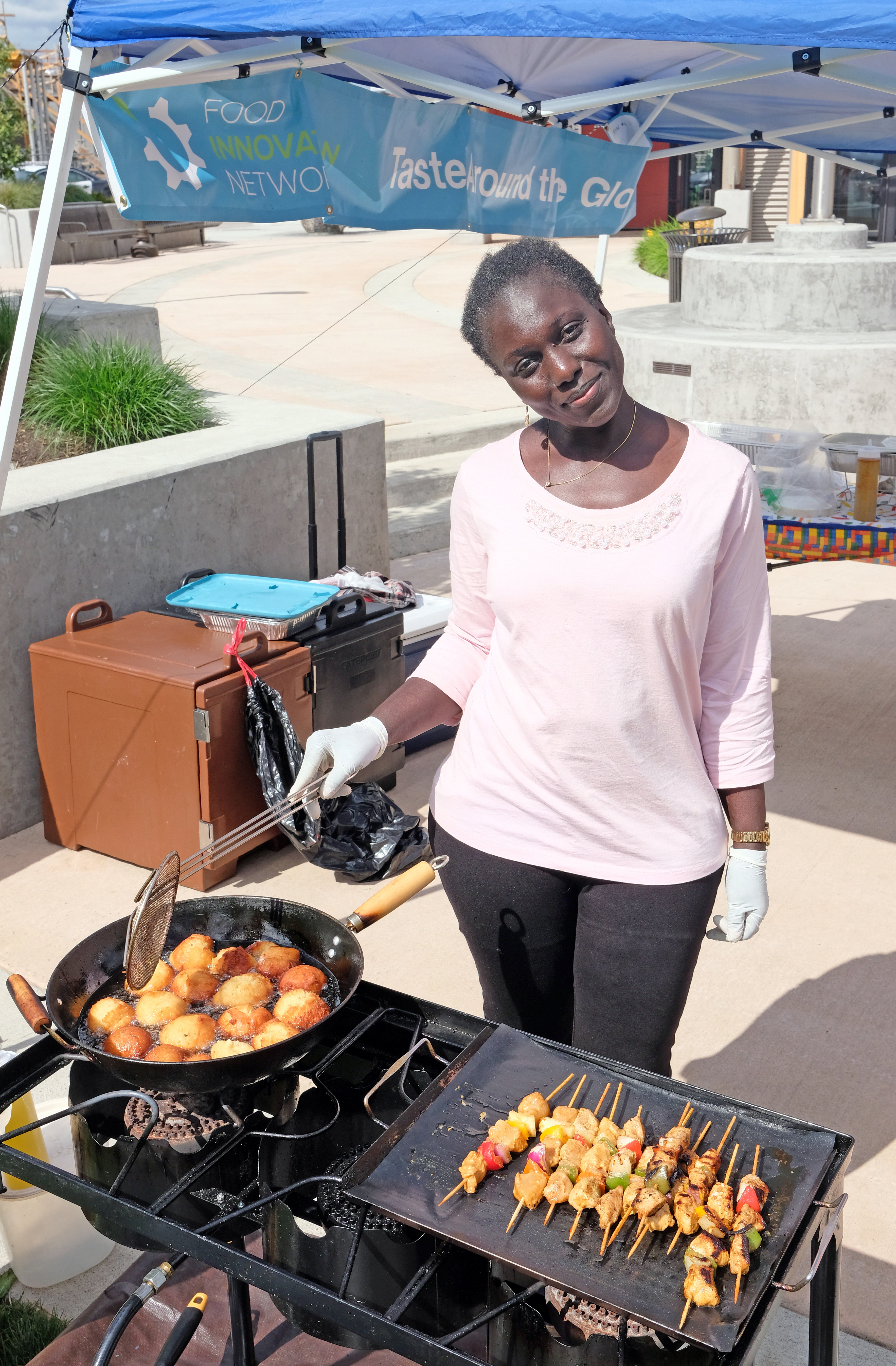 East and West Catering co-owner Adama Jammeh makes beignets and brochettes